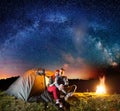 Tourists in camping at night against starry sky Royalty Free Stock Photo