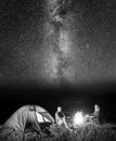 Tourists in camping at night against starry sky