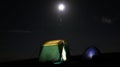 tourists camping tents with bright full moon