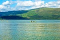 Tourists on canoe on calm blue Loch Lomond lake in Luss, Scotland, 21 July, 2016 Royalty Free Stock Photo