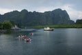 Tourists canoe to visit the island in Southern Thailand.