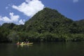 Tourists canoe to visit the island in Southern Thailand.