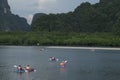 Tourists canoe to visit the island in Southern Thailand.