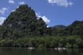 Tourists canoe to visit the island in Southern Thailand.