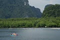 Tourists canoe to visit the island in Southern Thailand.