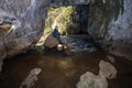 tourists-cavers explore the grotto in the atysh karst cave and the stream flowing from it. Bashkortosta