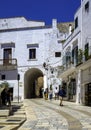 tourists in the characteristic streets of the historic center of Ostuni.