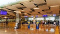 Tourists checking in for their flights in departures hall in international airport