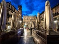 Tourists and citizens stroll in the evening in the illuminated herb square of romantic Verona, Italy