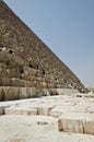 Tourists clamberig on the ruined wall of an Egyptian pyramid