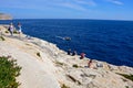 Tourists enjoying the view at Blue Grotto, Malta.