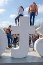 Tourists climb on the iAmsterdam sign at the Museum Square, in A