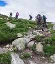 Tourists climb the mountain on the rocks, Jotunheimen National Park, Norway