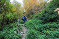 Tourists climb the mountain to the lake