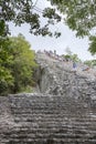 Tourists climb the Pyramid Nohoch Mul along the guiding rope at the Mayan Coba Ruins, Mexico Royalty Free Stock Photo