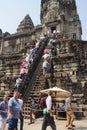 Tourists climb the steep steps