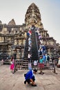 Tourists climb the steep steps to the highest temple of Angkor W