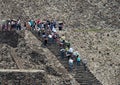 Tourists climb up the pyramid of the sun stairs