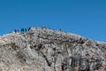 Tourists and Climbers Walking in Stone Path among Barren Mountains in Italian Dolomites Alps in Summer Time Royalty Free Stock Photo