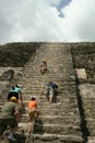 Tourists Climbing Mayan High Temple in Lamanai, Belize