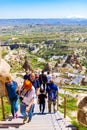 Tourists climbing stairs of Castle mountain Cappadocia UÃÂ§hisar Turkey