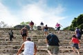 Tourists climbing the stairs of Mayan ruins