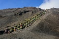 Tourists climbing stairway to the rim of Mount Bromo