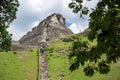 Tourists climbing the steep stairs to the Maya ruin `El Castillo` at the archeological site Xunantunich near San Ignacio, Belize