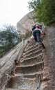 Climbers tackling steep stone stairs on Huashan mountain Royalty Free Stock Photo