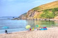 Tourists Coloured umbrellas Portwrinkle beach Whitsand Bay Cornwall England United Kingdom in colourful HDR Royalty Free Stock Photo