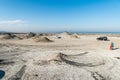 Tourists among cones of gryphon mud volcanoes in Gobustan, Azerbaijan