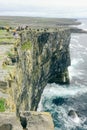 Tourists courageously look down a cliff