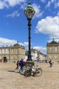 Tourists in the courtyard in front of the Amalienborg palace , sunny day, Copenhagen, Denmark