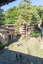 Tourists in the courtyard of the Troyan Monastery in Bulgaria Royalty Free Stock Photo