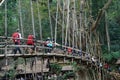 Tourists cross the bamboo bridge to get to the Inner Baduy traditional village