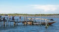 The tourists cross the bridge for a long tail boat