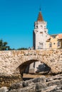 Tourists cross a bridge overlooking the exterior of Condes de Castro Guimaraes castle museum in Cascais, Portugal