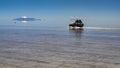 Tourists cross the flooded Salar de Uyuni. Uyuni, Bolivia