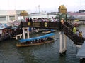 Tourists cross one of the bridges over the canal of the Amphawa Floating Market