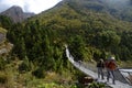 Tourists crossing a bridge in the Himalayas