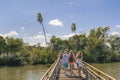 Tourists crossing the bridge which goes to devil throat falls