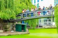 Tourists crossing the Camden Lock footbridge above Regents Canal