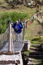 Tourists crossing a hanging bridge