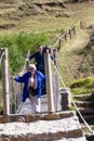 Tourists crossing a hanging bridge