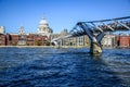 Tourists crossing the River Thames by walking through Millennium Bridge with Saint Paul`s Cathedral in background, London, UK Royalty Free Stock Photo