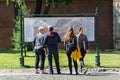 Tourists crowd around the map of the fortress on the paved area. Royalty Free Stock Photo