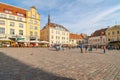 Tourists crowd the sidewalk cafes and shops in the medieval Tallinn Town Square in the walled city of Tallinn Estonia