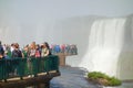 Tourists crowded on platform in waters of Iguacu river, at Iguacu Falls