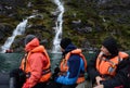 Tourists from the cruise ship near the waterfalls of the glacier Nena. Royalty Free Stock Photo