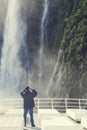 Tourists on the cruising boat approaching Stirling Falls , Milford Sound, Fiordland, South Island of New Zealand Royalty Free Stock Photo